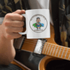 mockup of a musician holding an 11 oz coffee mug 33324